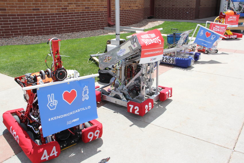 Robots line the walkway to Cherry Hills Community Church May 15 during a memorial service for Kendrick Castillo. The robots bore signs including Castillo’s name and heart symbols.